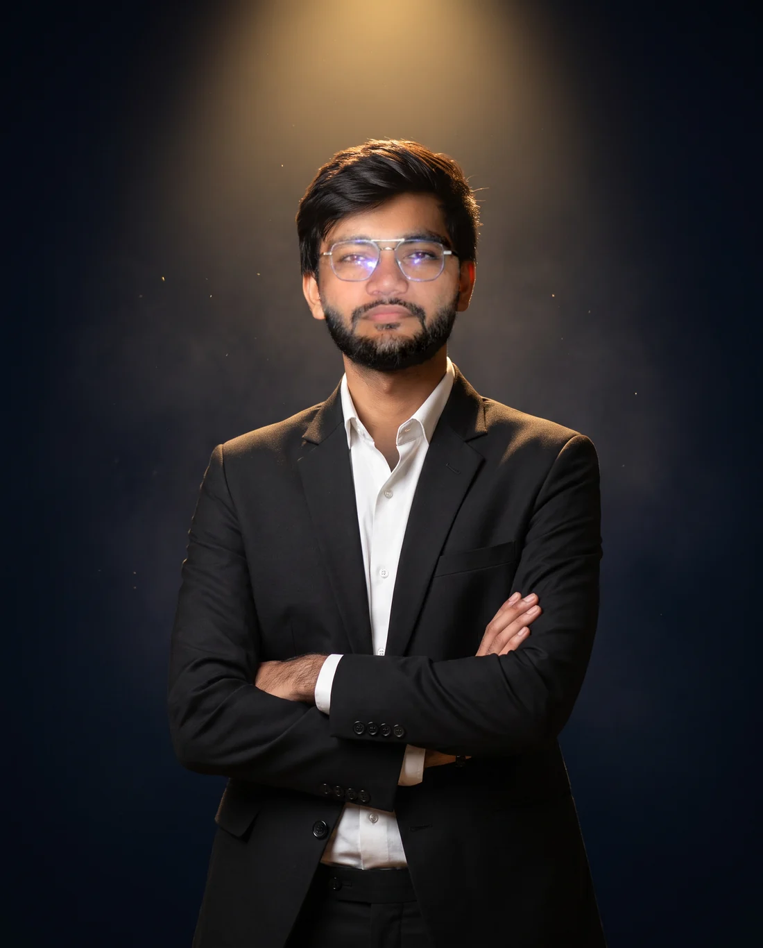 Nil Sakariya in a black suit, arms crossed